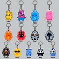 Grid of flat 2D character keychains on silver key rings, including a yellow banana-shaped character, a pink and blue llama, a blue water drop, a pink ghost, an orange flame, a red horned boss, a hooded skull, a gray hooded figure, a long-haired man in black, a duck in sunglasses, a blue stitched character, a crowned skull and a soccer-themed character, each with a name label | sgc-photo-ok