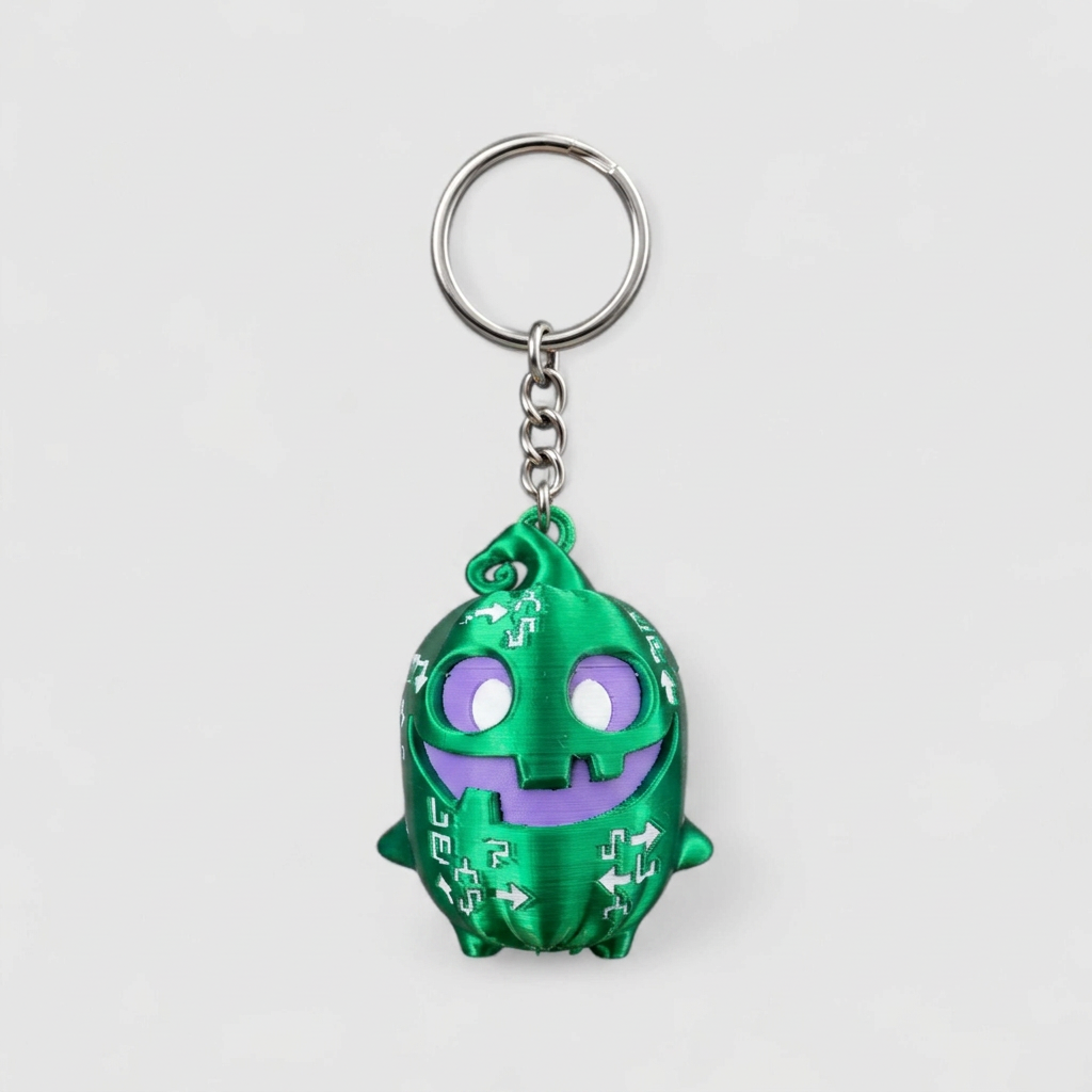 Green spooky sprite keychain with silver ring and chain hardware on grey background