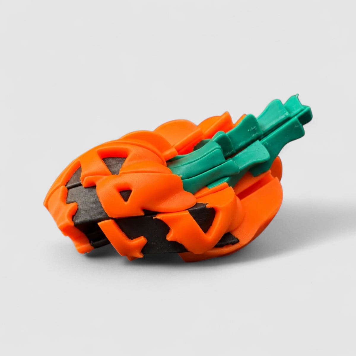Jack-O-Twist Pumpkin Fidget, 3D printed figure on grey background | sgc-photo-v1